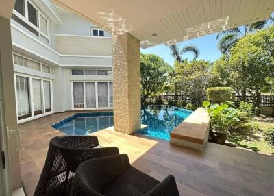 Luxurious outdoor patio with a swimming pool and garden view