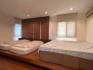 Spacious bedroom with twin beds and modern wooden wall paneling