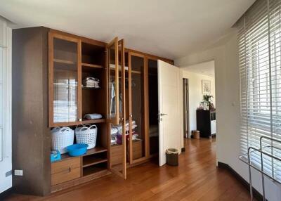 Cozy bedroom with wooden wardrobe and hardwood flooring