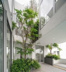 Modern building facade with an integrated green space and glass elements