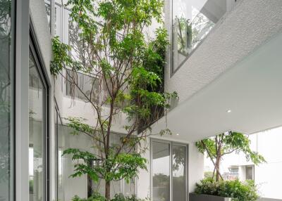 Modern building facade with an integrated green space and glass elements