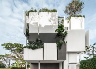 Modern multi-level building with greenery and garage space