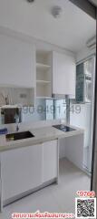 Modern kitchen interior with white cabinetry and stainless steel sink