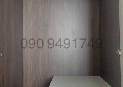 Spacious built-in wooden wardrobe with shelving and drawer unit