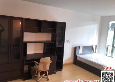 Spacious bedroom with large bed and shelving units