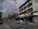 Urban street with residential buildings and local shops