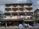 Multi-story residential building with retail shops on the ground floor