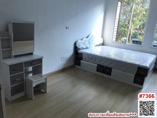 Modern bedroom with large window and wooden floor