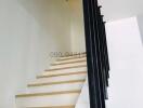 Modern white staircase with black railing