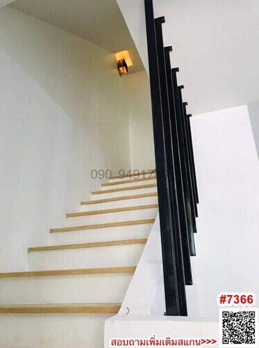 Modern white staircase with black railing