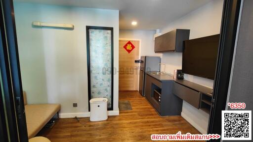 Compact kitchen area with modern appliances and wooden flooring