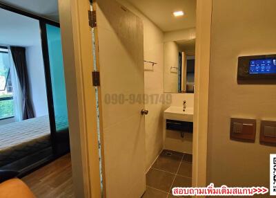 Modern bedroom with en-suite bathroom and smart home control panel
