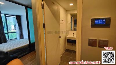 Modern bedroom with en-suite bathroom and smart home control panel