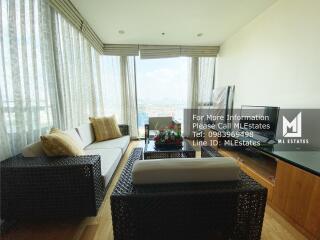 Spacious living room with large windows and city view