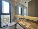 Modern bathroom with city view through large window