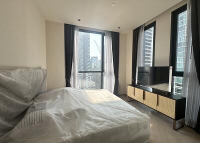 Modern bedroom interior with city view through large windows