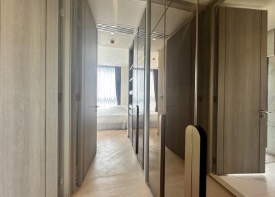 Spacious hallway leading to bedroom and bathroom with mirrored closet doors