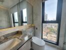 Modern bathroom with marble finish and city view