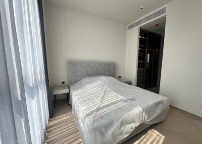 Modern bedroom with a large bed and natural light