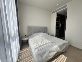 Modern bedroom with a large bed and natural light