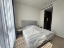 Modern bedroom with a large bed and natural light