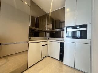 Modern kitchen with white cabinets and built-in appliances