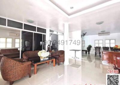 Spacious and bright living room with wicker furniture and tiled flooring