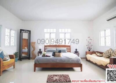 Spacious and well-lit bedroom with comfortable furnishings and modern decor
