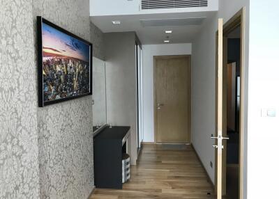 Modern hallway interior with decorative wallpaper and wooden flooring