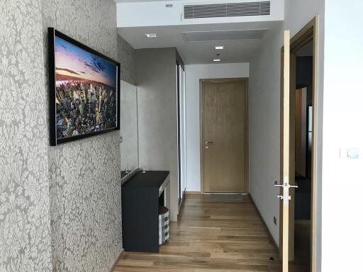 Modern hallway interior with decorative wallpaper and wooden flooring