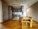 Open plan kitchen with dining area featuring hardwood floors, modern appliances, and natural light