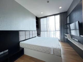 Modern bedroom interior with large window and city view