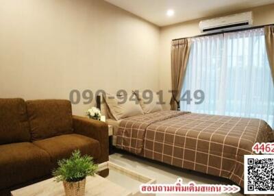 Cozy bedroom with a comfortable bed, a sofa, and a modern air conditioning unit
