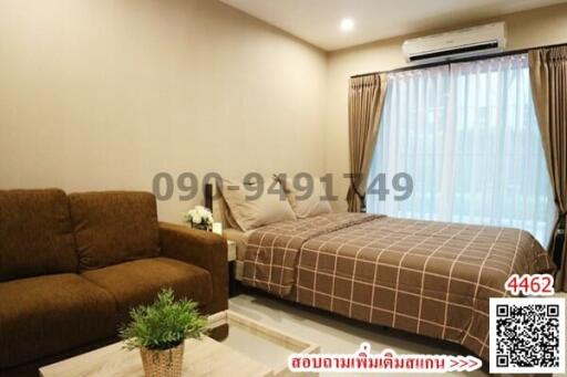 Cozy bedroom with a comfortable bed, a sofa, and a modern air conditioning unit