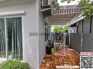 Exterior view of a modern house with a tiled patio and air conditioning unit