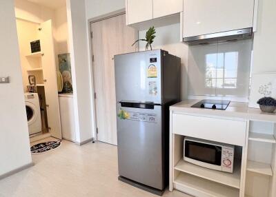 Modern kitchen with white cabinets and stainless steel appliances