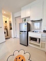 Modern kitchen with white cabinets and stainless steel appliances