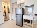 Modern kitchen with white cabinets and stainless steel appliances