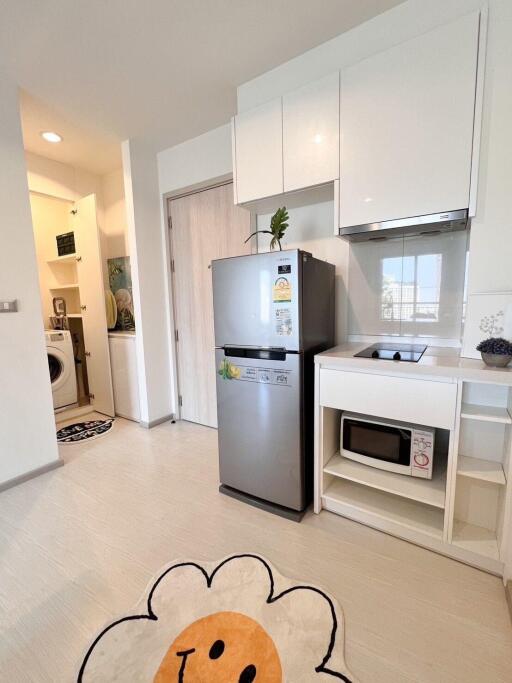 Modern kitchen with white cabinets and stainless steel appliances