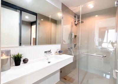 Modern white bathroom with bathtub and glass shower