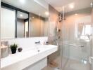 Modern white bathroom with bathtub and glass shower