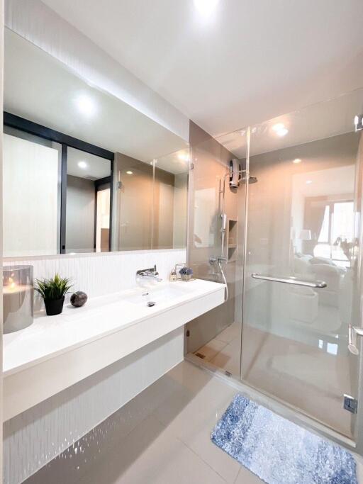 Modern white bathroom with bathtub and glass shower