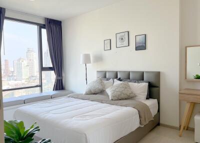 Modern bedroom with well-lit interior and city view