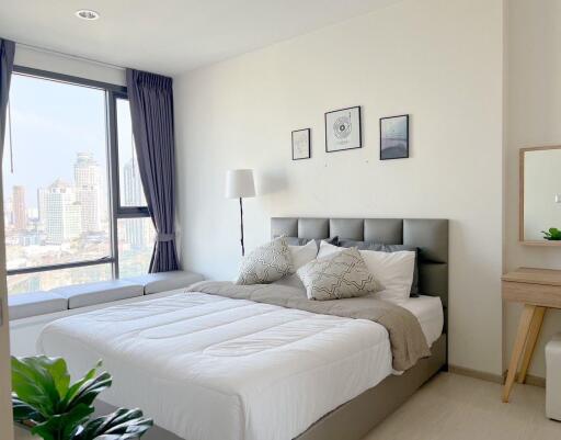 Modern bedroom with well-lit interior and city view