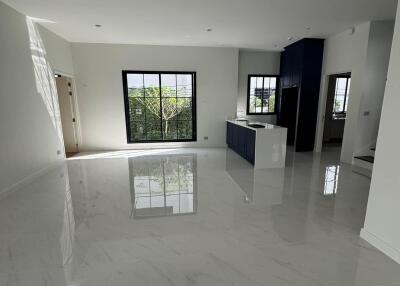 Bright and spacious modern open concept living area with glossy tiled flooring and large windows