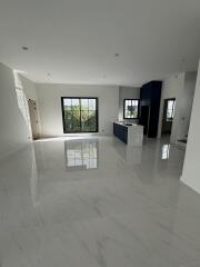 Bright and spacious modern open concept living area with glossy tiled flooring and large windows
