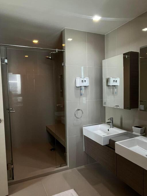 Modern residential bathroom with a glass shower enclosure