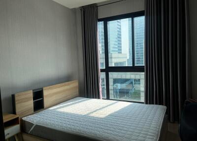 Contemporary bedroom with large window and city view