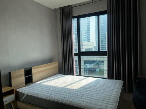 Contemporary bedroom with large window and city view