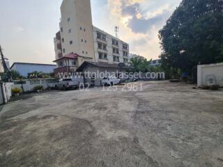 Spacious outdoor area with parking in front of a residential building